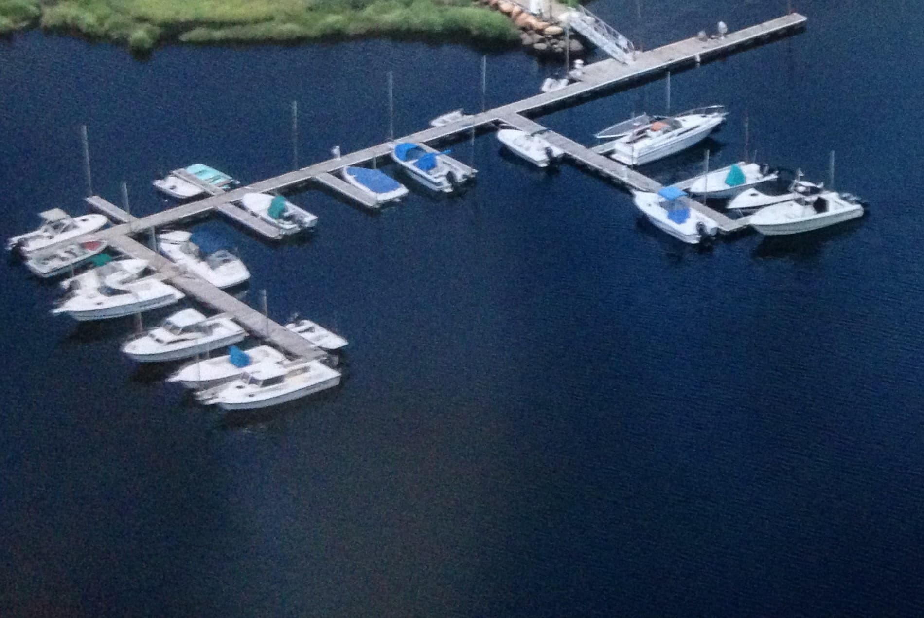 Boats in their slips along the floating docks at Wareham Marina